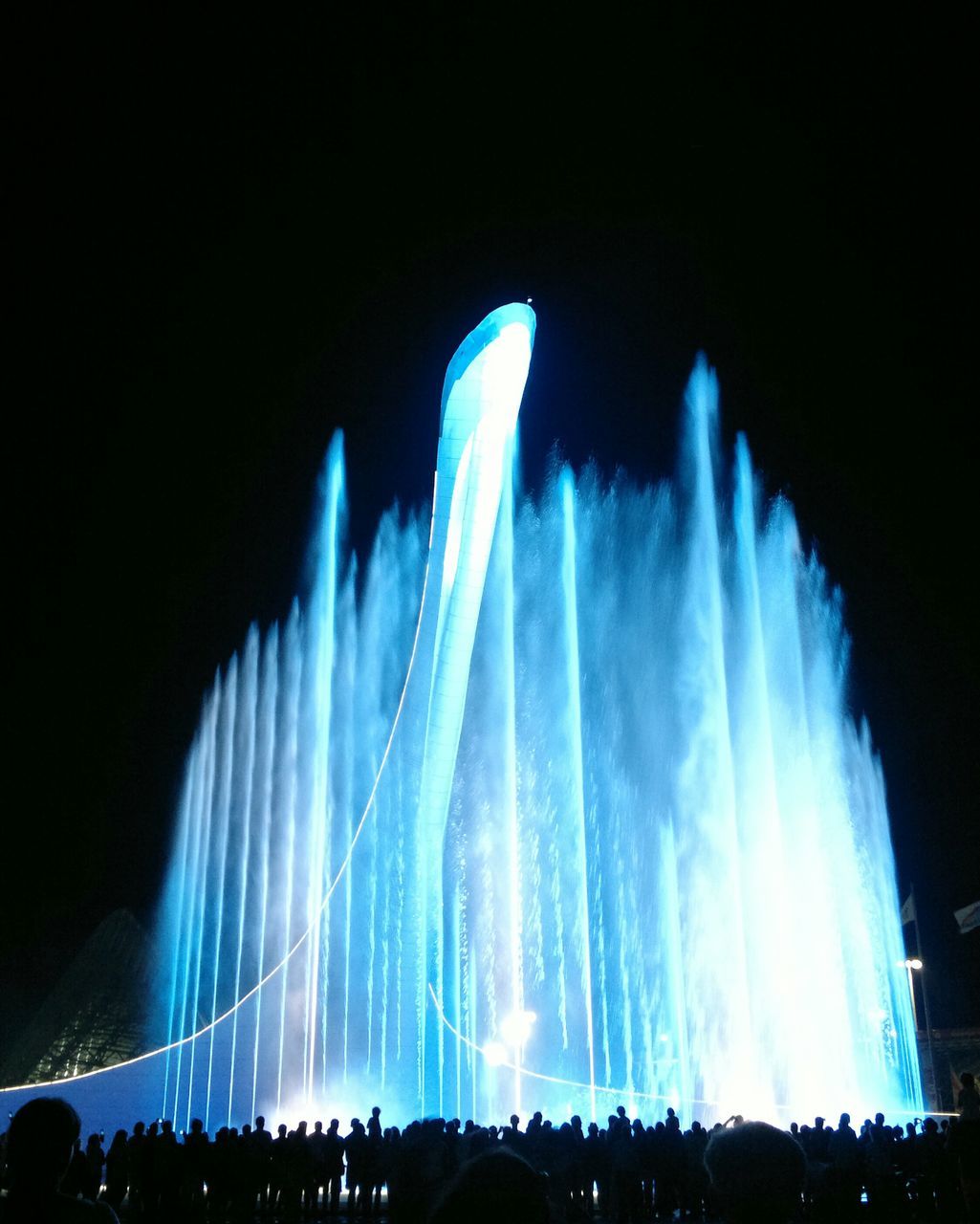 night, fountain, long exposure, arts culture and entertainment, motion, illuminated, spraying, low angle view, blue, sky, famous place, large group of people, travel destinations, international landmark, clear sky, tourism, water, blurred motion, event, travel