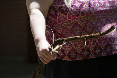 Midsection of woman holding umbrella