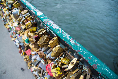 High angle view of padlocks on bridge over river