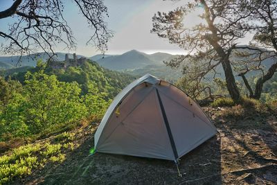 Scenic view of tent on mountain against sky