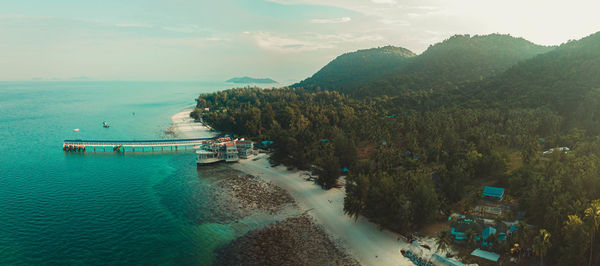 High angle view of sea and mountains against sky