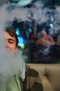 Close-up of portrait of man smoking