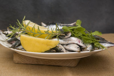 Close-up of fresh sardines in plate on table