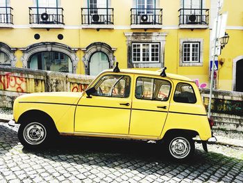 Vintage car on street against buildings