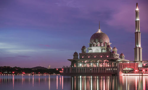 Putra mosque in lake against sky at dusk