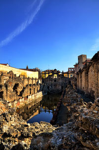 View of old buildings against blue sky