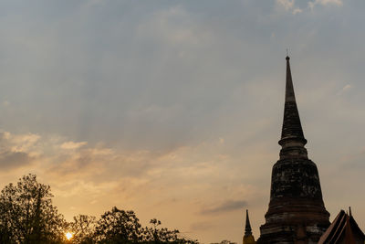 Low angle view of temple building against sky during sunset