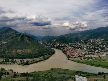 Cityscape against cloudy sky