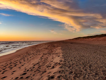 Scenic view of beach against sky during sunset