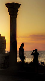 Statue of people at sunset