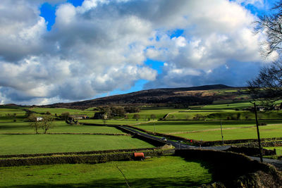 Scenic view of agricultural field against sky