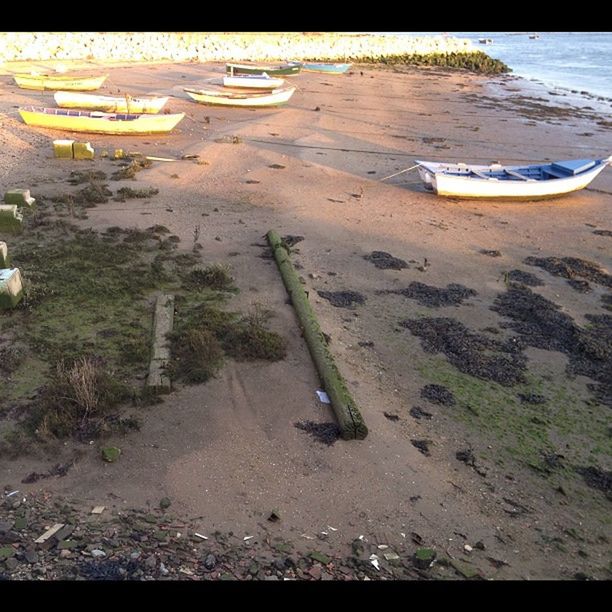 moored, water, nautical vessel, boat, transportation, beach, mode of transport, high angle view, sand, sea, shore, tranquility, sunlight, outdoors, reflection, nature, absence, no people, day, tranquil scene