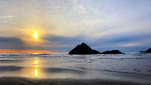 Scenic view of sea against sky at sunset