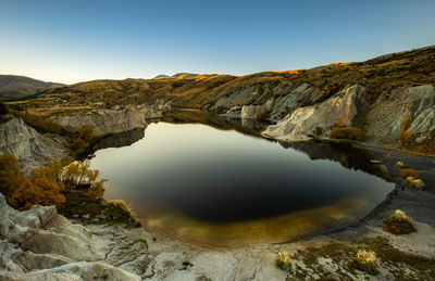 Blue lake is a small lake adjacent to the town of saint bathans in central otago, new zealand
