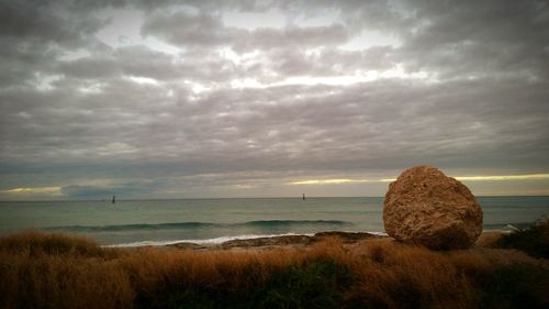 Scenic view of sea against cloudy sky