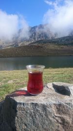 Close-up of tea cup against sky