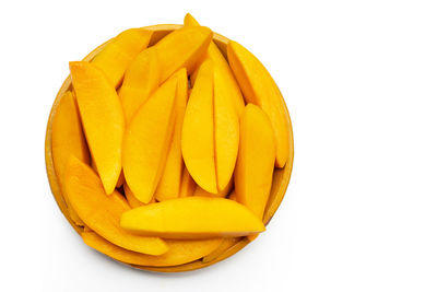 Close-up of yellow fruit against white background