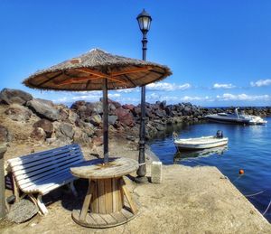 A bench over looking a little fishing port in santorini