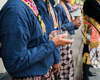 Midsection of people standing on road