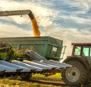 Tractor on agricultural field against sky