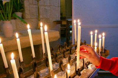 Illuminated candles burning in temple