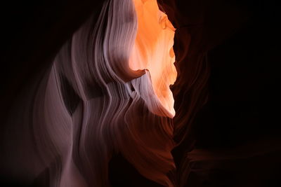 Low angle view of rock formation against black background