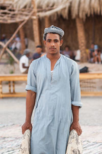 Portrait of young man standing outdoors