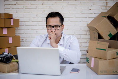 Portrait of young man using laptop