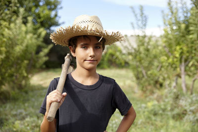 Portrait of a farmer boy in the orchard. having fun in the countryside.