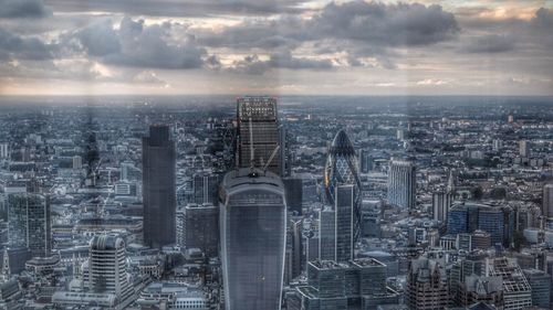 Skyscrapers against cloudy sky