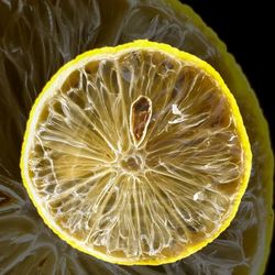 Close-up of lemon slice over black background