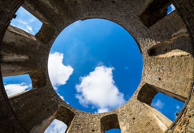 Low angle view of blue sky seen through arch