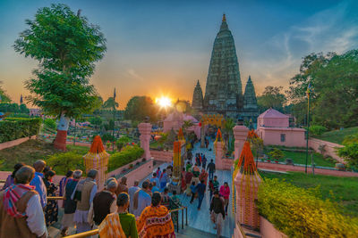 People at temple against building