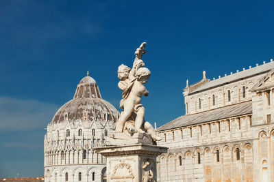 Low angle view of statue against blue sky