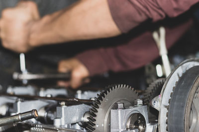 The mechanic is checking the engine.