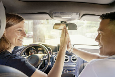 Portrait of smiling woman sitting in car