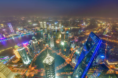 High angle view of illuminated city buildings at night