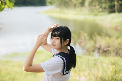 Student wearing school uniform while standing in park