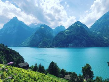 Scenic view of lake and mountains against sky