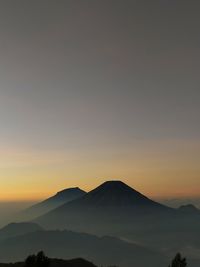 Scenic view of silhouette mountains against sky during sunset