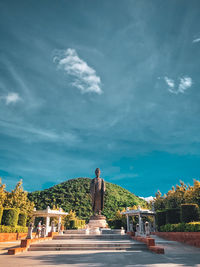 Woman standing by plants against sky