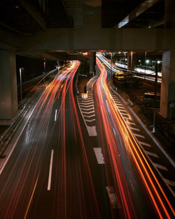 High angle view of light trails on road at night