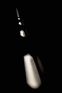 Close-up of illuminated lamp over black background