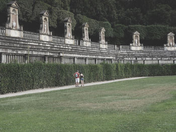 People standing by plants in park