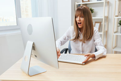 Businesswoman using laptop on table