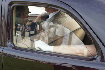 Reflection of people on car window