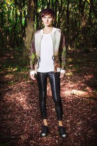 Portrait of a young man standing in forest