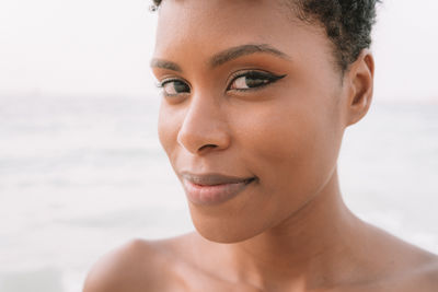 Close-up portrait of woman at beach