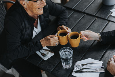 Senior woman sitting in outdoor cafe