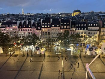 High angle view of crowd on city street against buildings